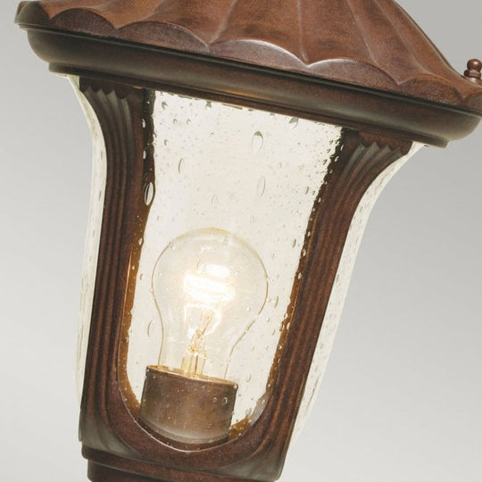Chicago Pedestal Lantern Small with a rusty bronze patina finish
